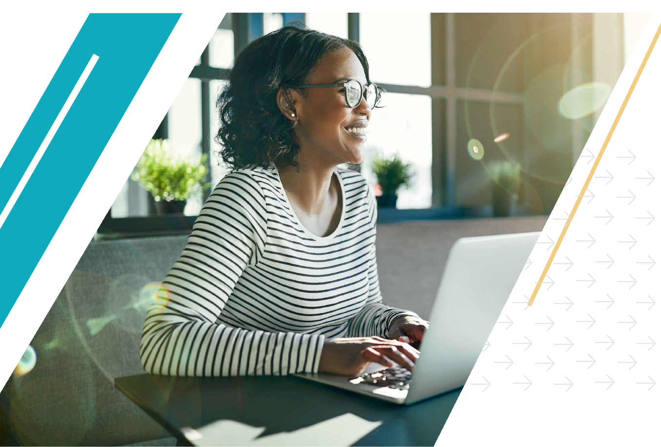 African American woman smiling while working on her laptop