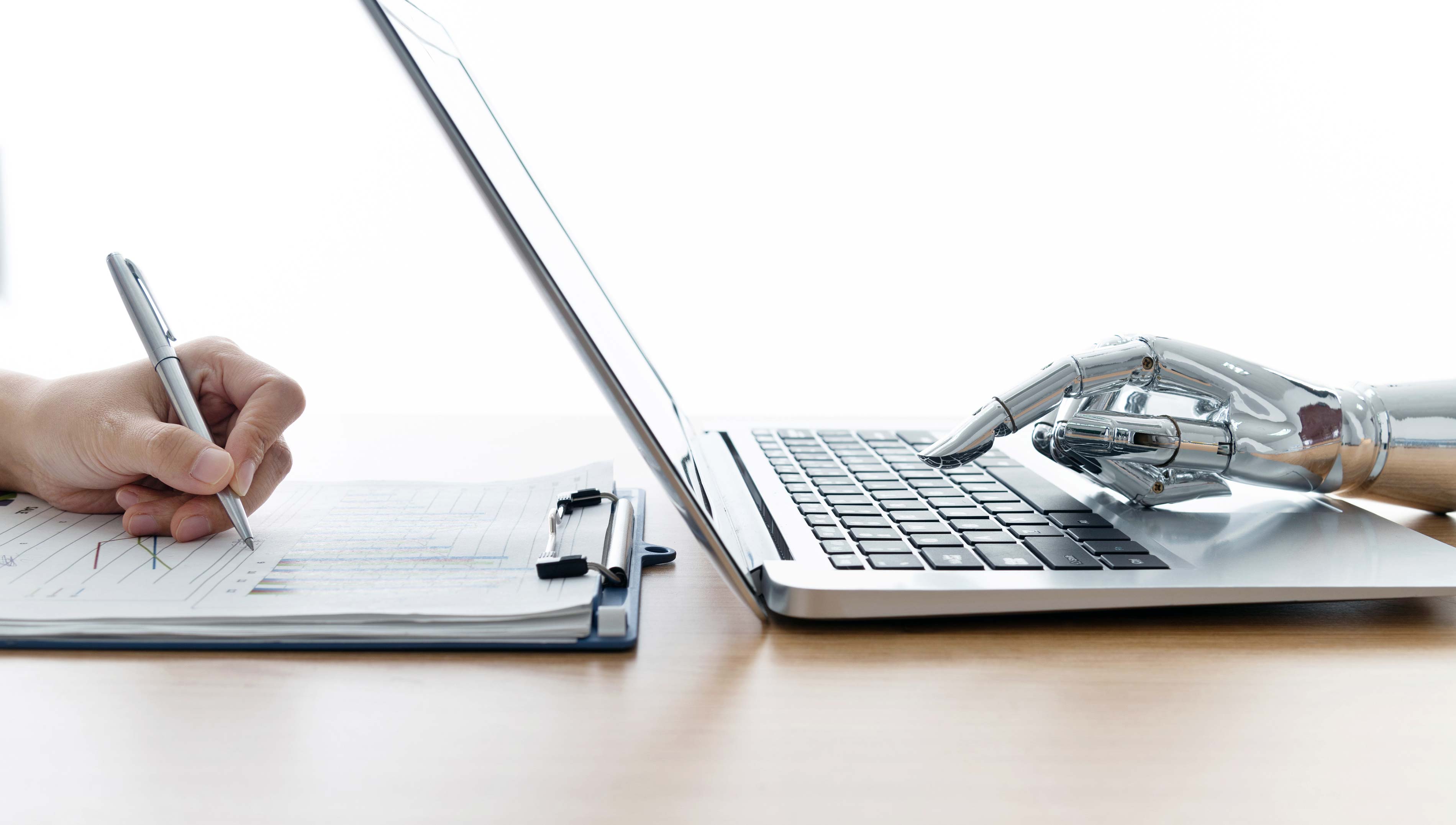 Robot hand using laptop and man hand writing stock photo