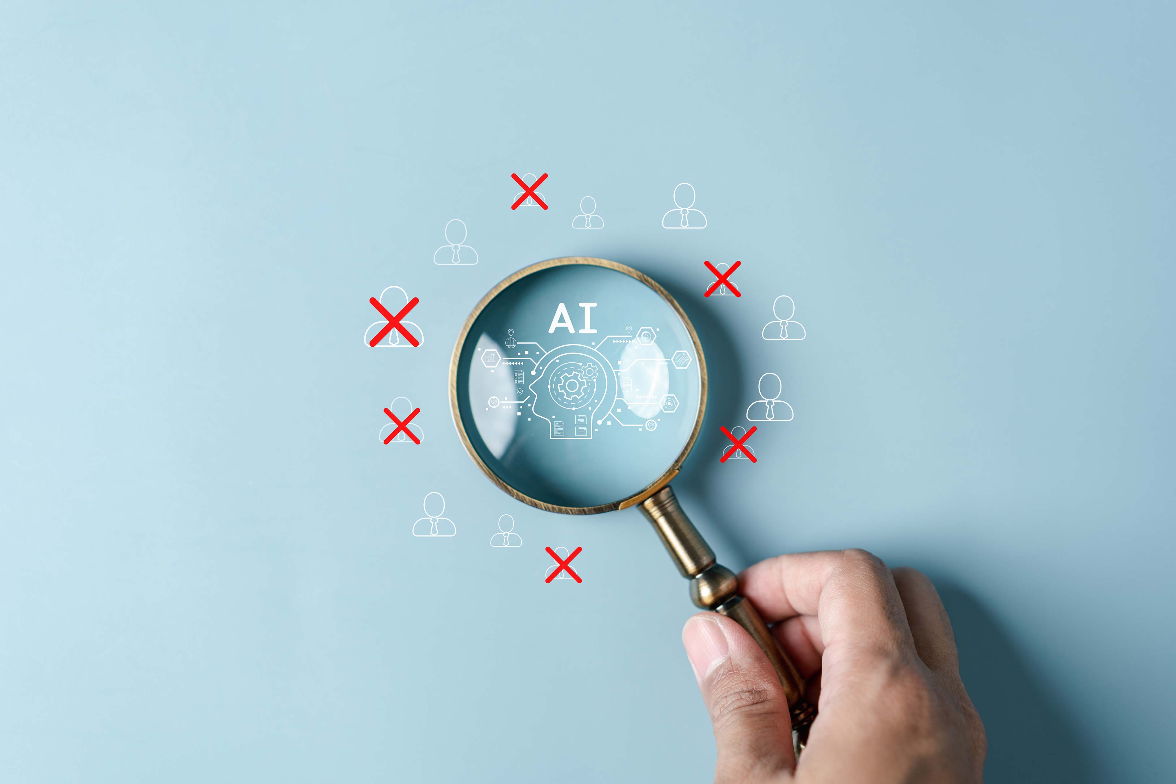 Image of a hand holding a magnifying glass over letters that spell AI