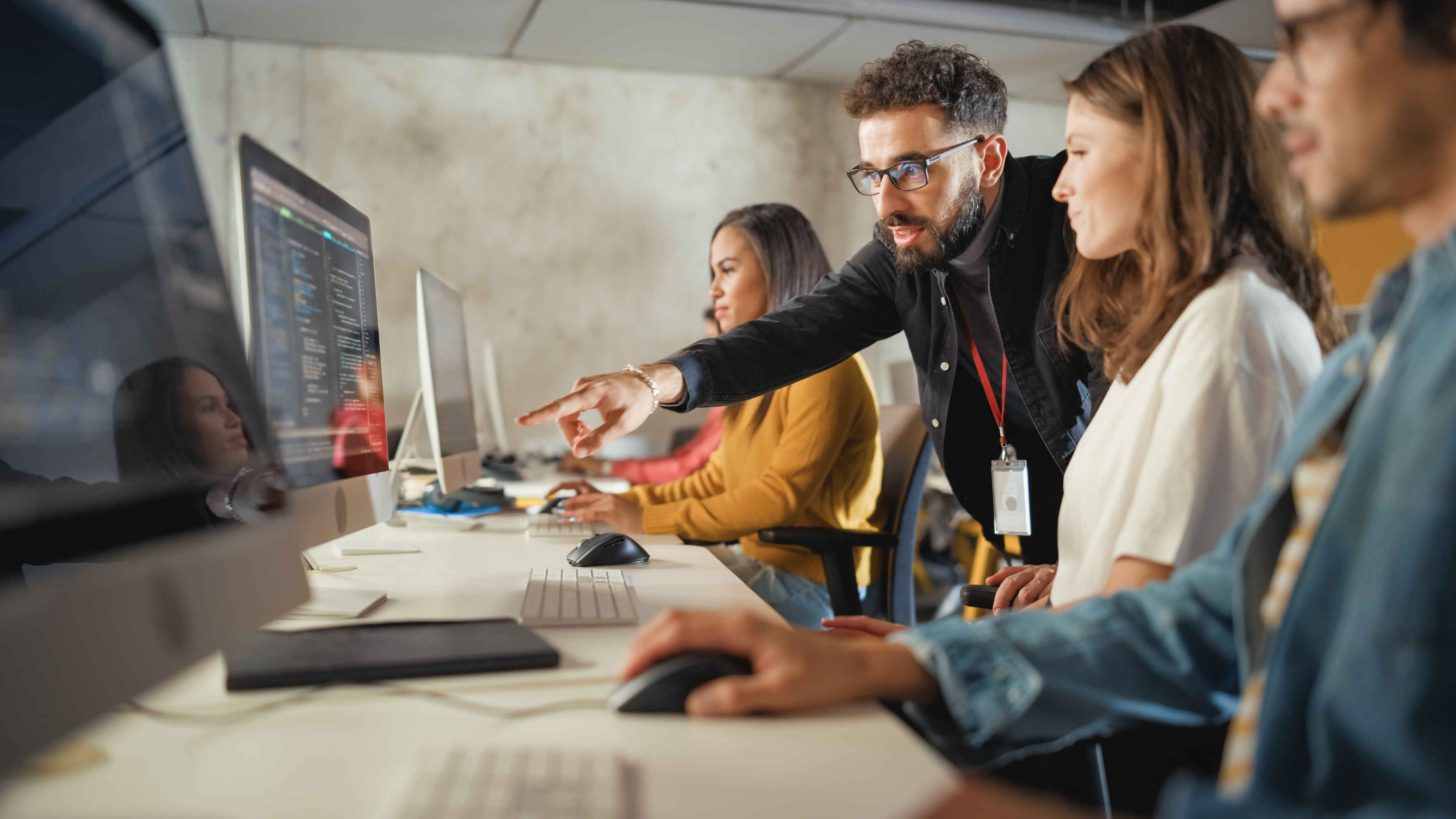 Lecturer Helps Scholar with Project, Advising on Their Work. Teacher Giving Lesson to Diverse Multiethnic Group of Female and Male Students in College, Teaching Computer Science and Writing Code.