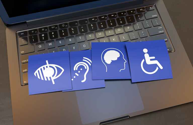 Disability signs overlaying a laptop