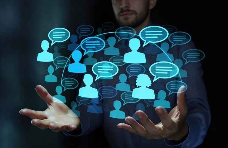 Person holding virtual social network interface with connected user icons and chat bubbles