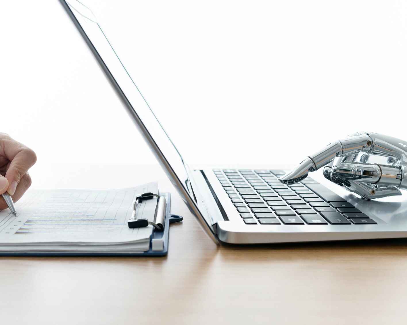 Robot hand using laptop and man hand writing stock photo