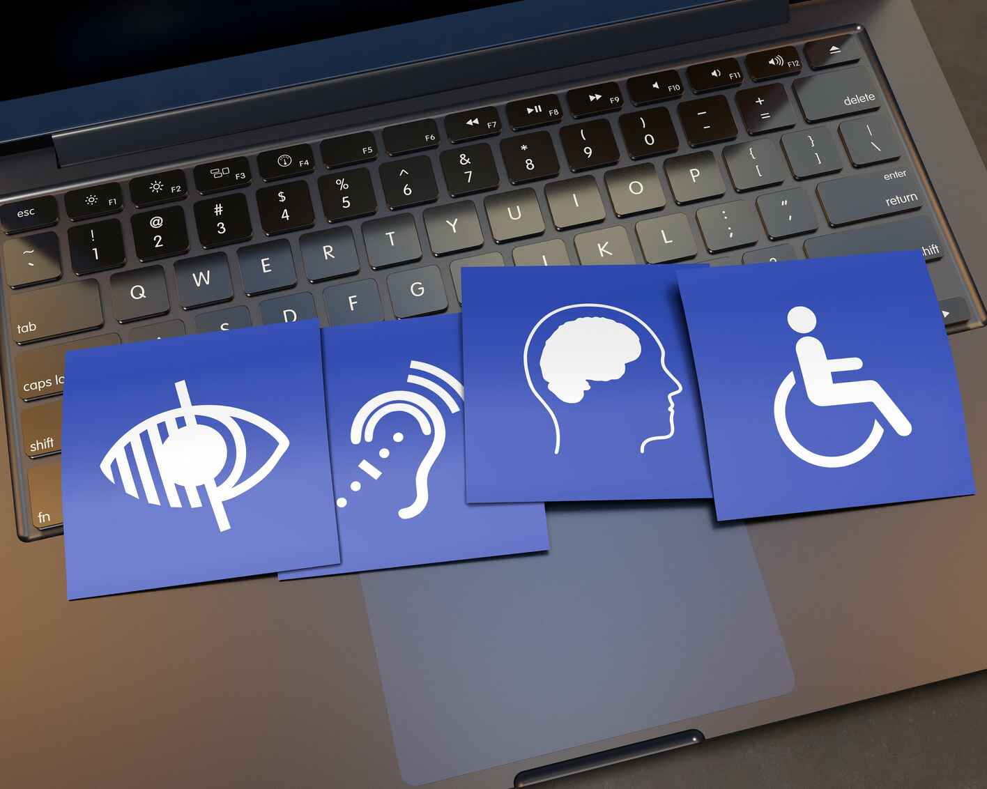 Disability signs overlaying a laptop