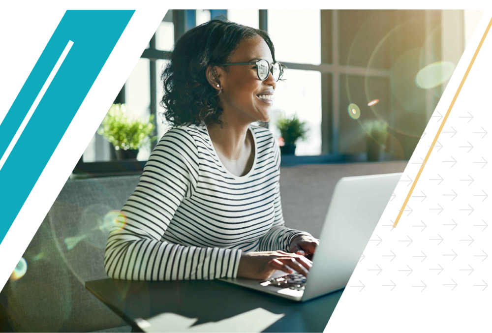 African American woman smiling while working on her laptop