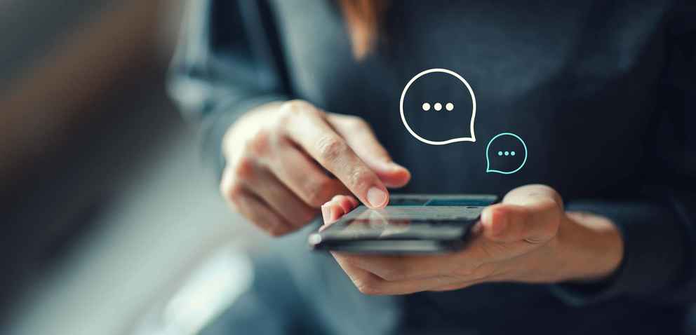 Woman's hands typing on mobile smartphone